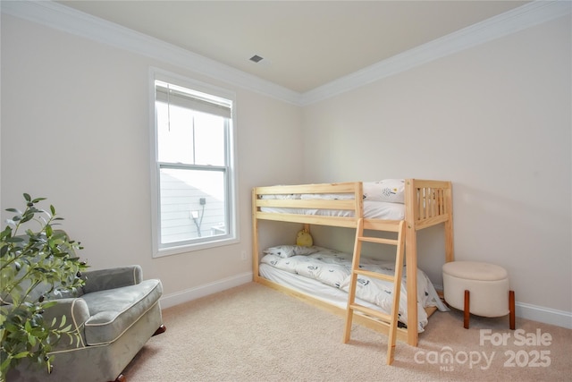 bedroom with carpet floors, crown molding, and baseboards