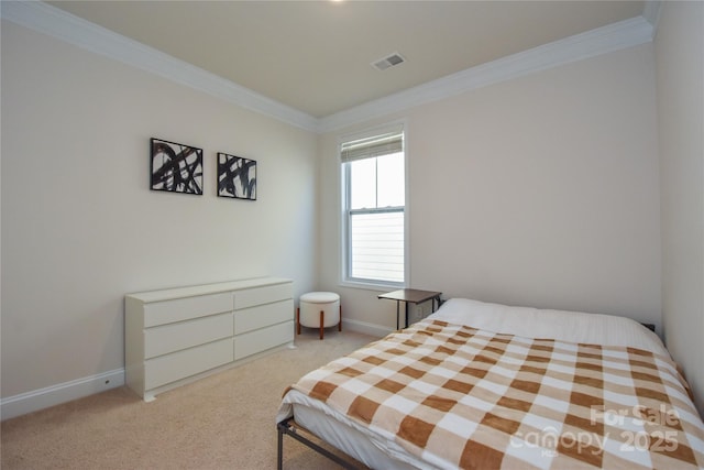 carpeted bedroom featuring baseboards, visible vents, and crown molding