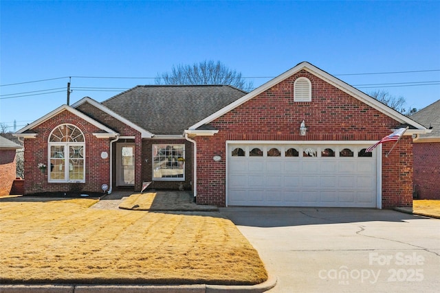 view of front of property featuring an attached garage, brick siding, driveway, and roof with shingles