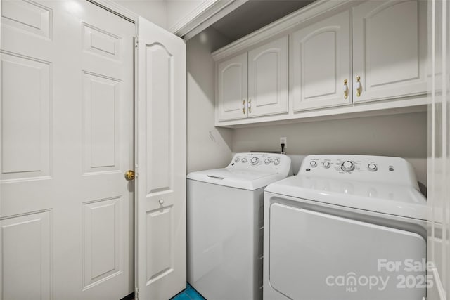 laundry room featuring cabinet space and washing machine and clothes dryer