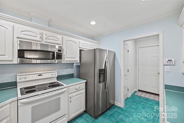 kitchen featuring recessed lighting, appliances with stainless steel finishes, white cabinets, and crown molding