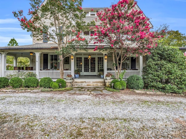 back of house featuring covered porch, french doors, and ceiling fan