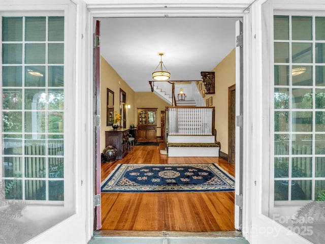 entryway with stairway and wood finished floors