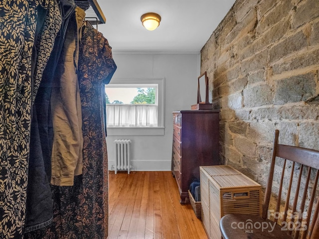 interior space with radiator heating unit and hardwood / wood-style flooring