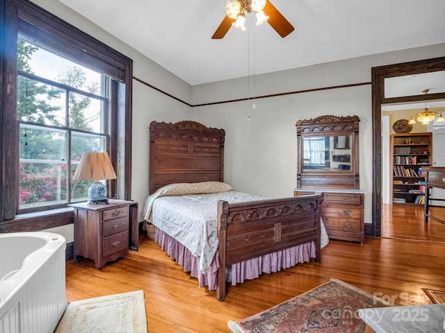 bedroom featuring light wood finished floors and a ceiling fan