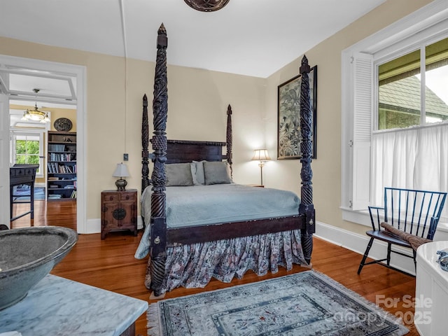 bedroom featuring baseboards and wood finished floors