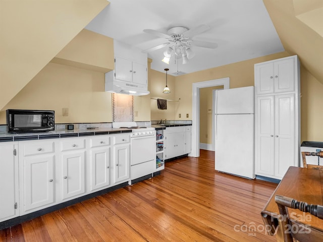 kitchen featuring ceiling fan, under cabinet range hood, light wood-style flooring, white appliances, and white cabinetry