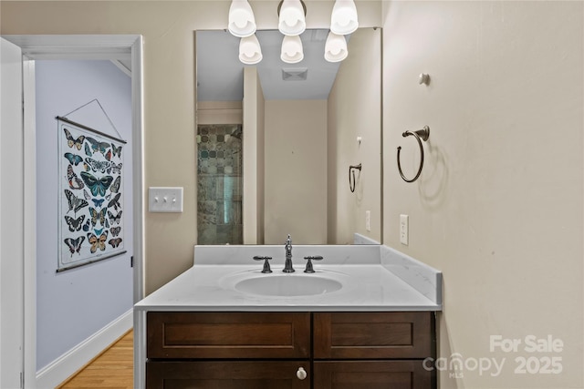 bathroom featuring visible vents, wood finished floors, and vanity