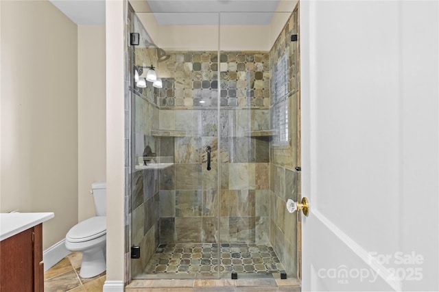 bathroom featuring a stall shower, vanity, and toilet