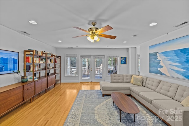 living area with recessed lighting, a ceiling fan, visible vents, light wood-style floors, and french doors