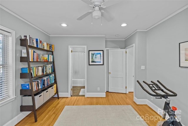 interior space featuring baseboards, crown molding, and wood finished floors