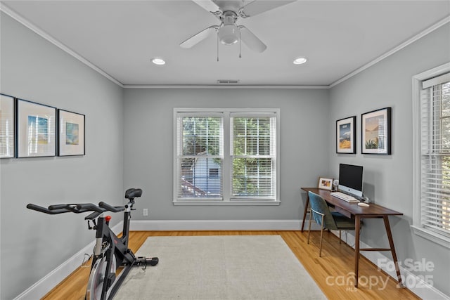 workout area with visible vents, crown molding, baseboards, and wood finished floors