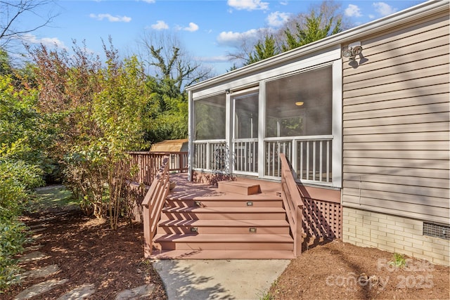 deck with a sunroom and stairway