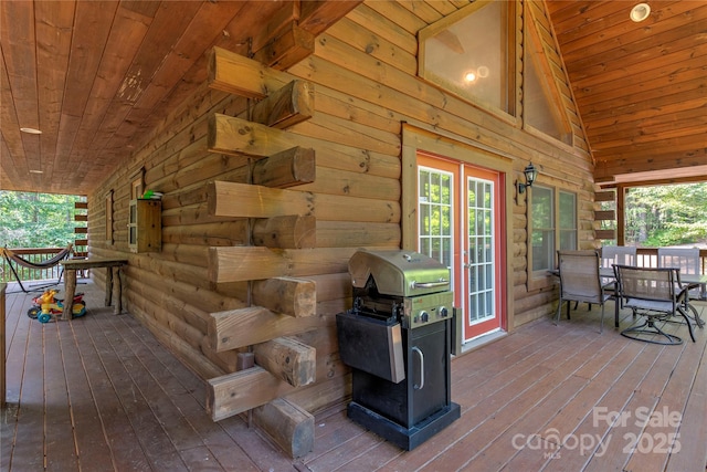 wooden deck featuring french doors and outdoor dining area