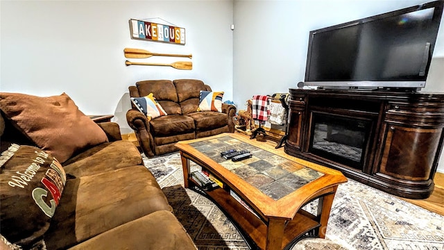 living room featuring a glass covered fireplace