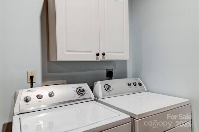 laundry area with cabinet space and independent washer and dryer