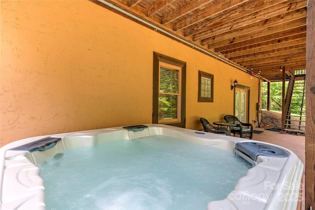 view of pool with an indoor hot tub and french doors