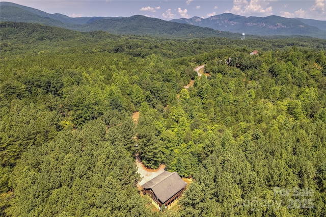 drone / aerial view with a wooded view and a mountain view