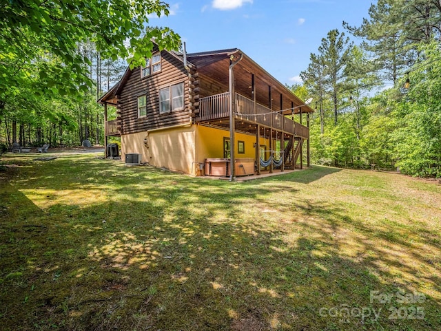145 Jobes Trl, Mill Spring, NC 28756 - rear view of house with an attached garage, a wooden deck, log exterior, and a yard