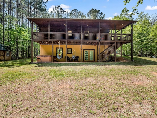 145 Jobes Trl, Mill Spring, NC 28756 - rear view of house with a wooden deck, french doors, stairs, a hot tub, and a yard