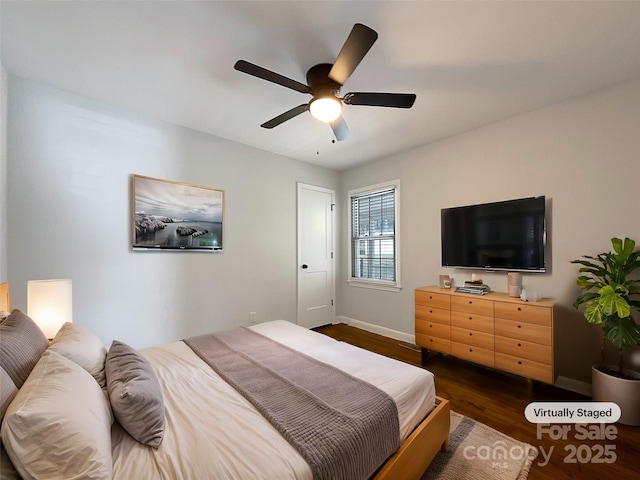 bedroom featuring ceiling fan, dark wood-style flooring, and baseboards