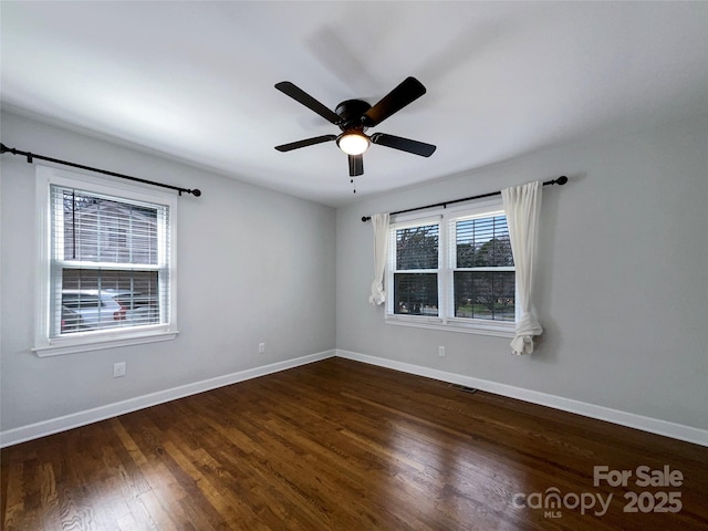 unfurnished room featuring visible vents, ceiling fan, baseboards, and wood finished floors