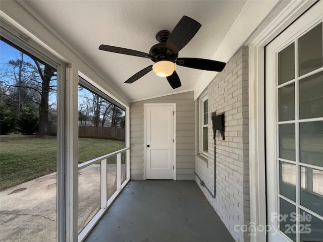 unfurnished sunroom featuring lofted ceiling and ceiling fan