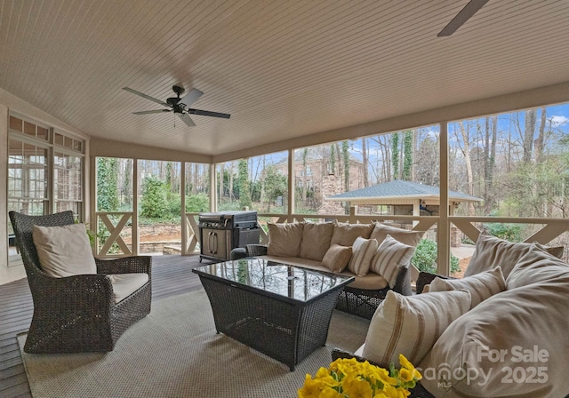 sunroom / solarium featuring plenty of natural light and a ceiling fan