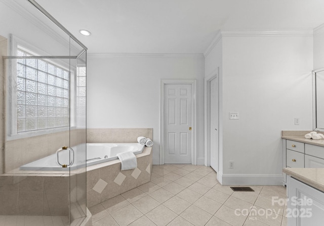 full bath with tile patterned floors, vanity, crown molding, and a garden tub