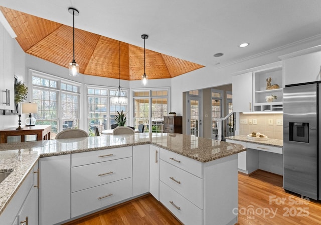 kitchen featuring light wood finished floors, open shelves, stainless steel fridge with ice dispenser, wooden ceiling, and backsplash