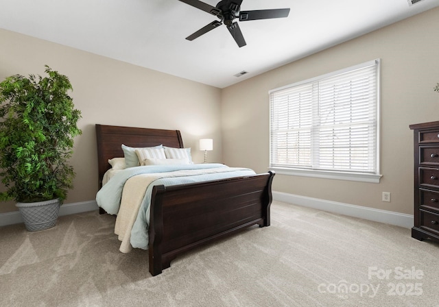 bedroom featuring baseboards, light carpet, and visible vents