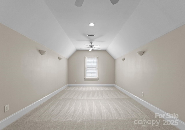 bonus room featuring visible vents, baseboards, light colored carpet, ceiling fan, and vaulted ceiling