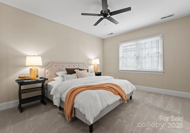 bedroom featuring visible vents, light carpet, baseboards, and ceiling fan