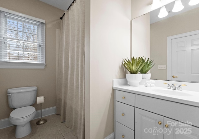 bathroom featuring vanity, a shower with shower curtain, baseboards, tile patterned flooring, and toilet