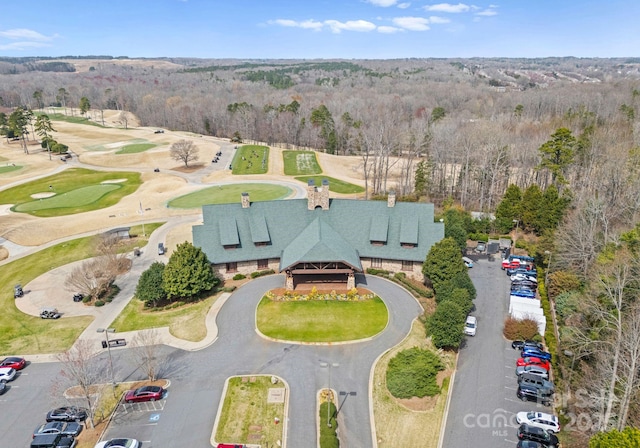 drone / aerial view with a wooded view