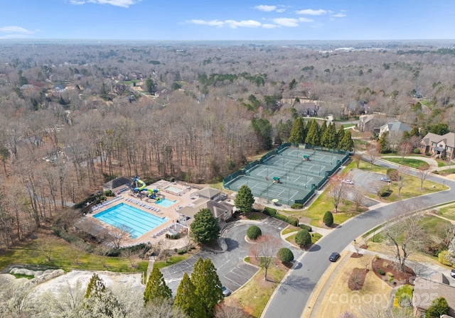 birds eye view of property with a wooded view