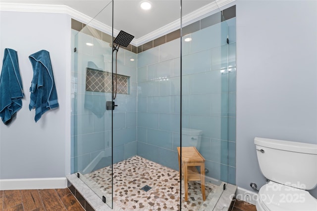 full bath with crown molding, a shower stall, and wood finished floors