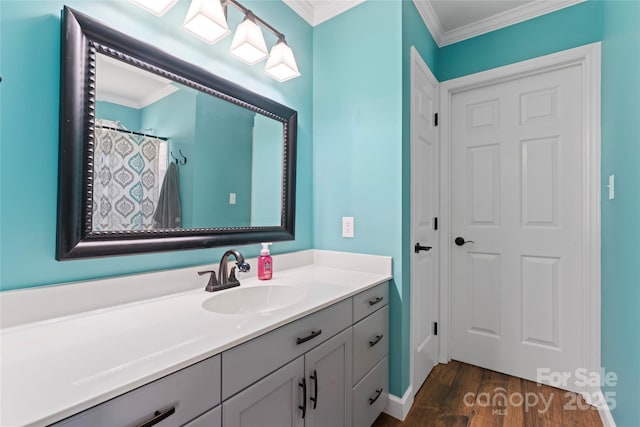 bathroom with crown molding, vanity, and wood finished floors