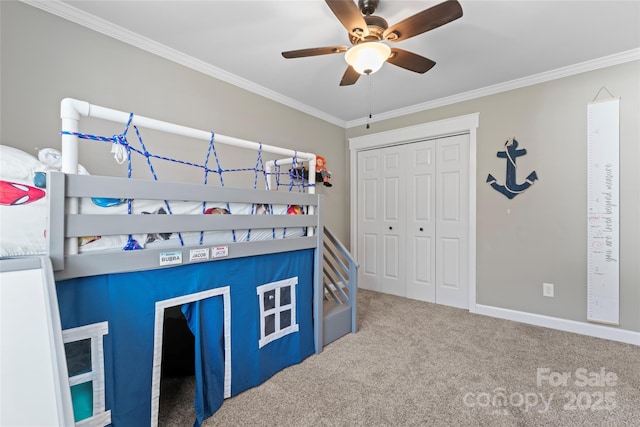 bedroom featuring ornamental molding, a closet, carpet, and baseboards