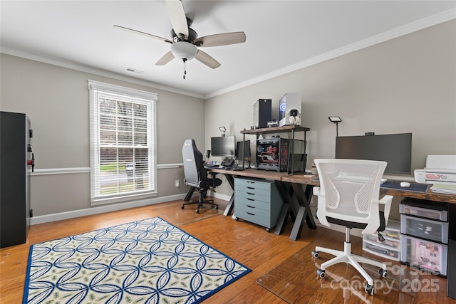 office space featuring visible vents, crown molding, baseboards, and wood finished floors