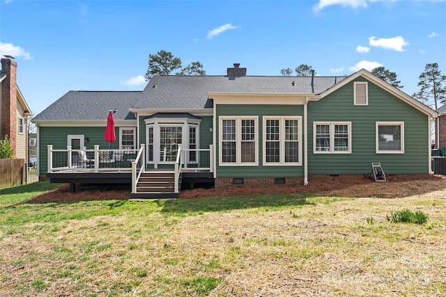 rear view of house with a wooden deck, crawl space, fence, and a lawn