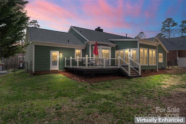 back of property featuring a chimney, a lawn, crawl space, a deck, and a fenced backyard