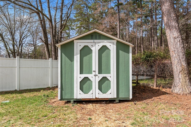 view of shed featuring fence