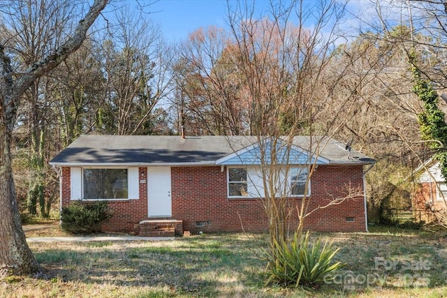 ranch-style home featuring brick siding and crawl space