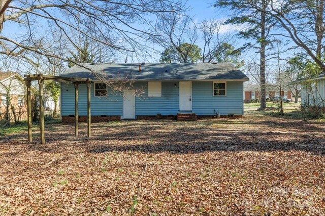 rear view of house featuring entry steps and crawl space