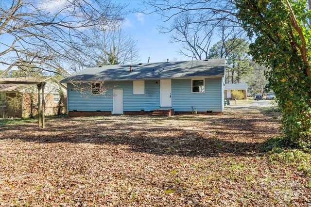 rear view of house with crawl space and entry steps