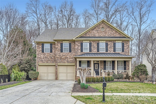 view of front facade with driveway, a standing seam roof, a porch, a garage, and brick siding