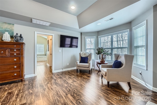 living area with visible vents, dark wood-style flooring, and baseboards