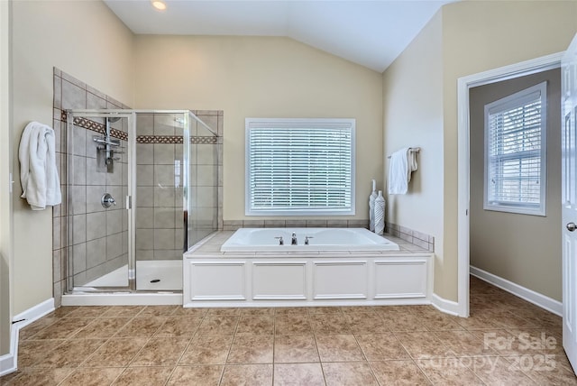 bathroom featuring lofted ceiling, a bath, a shower stall, and tile patterned flooring