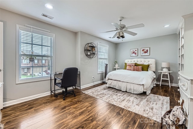 bedroom with visible vents, multiple windows, baseboards, and dark wood-style flooring